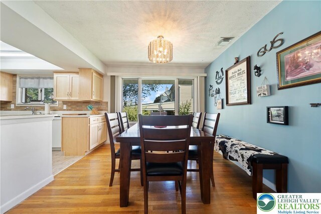 275 E Thomas Ave, Hellertown Boro, PA 18055 - dining area featuring a chandelier, light wood finished floors, and a textured ceiling