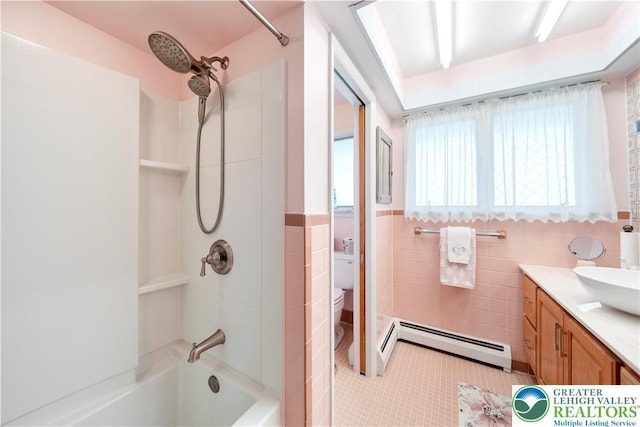 275 E Thomas Ave, Hellertown Boro, PA 18055 - bathroom with a baseboard radiator, shower / bathtub combination, vanity, tile walls, and wainscoting