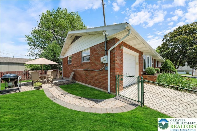 275 E Thomas Ave, Hellertown Boro, PA 18055 - view of property exterior with a gate, brick siding, an attached garage, and driveway