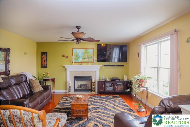3104 Peacock Dr, Bethlehem Twp, PA 18020 - living room featuring a ceiling fan, healthy amount of natural light, wood finished floors, and a tiled fireplace