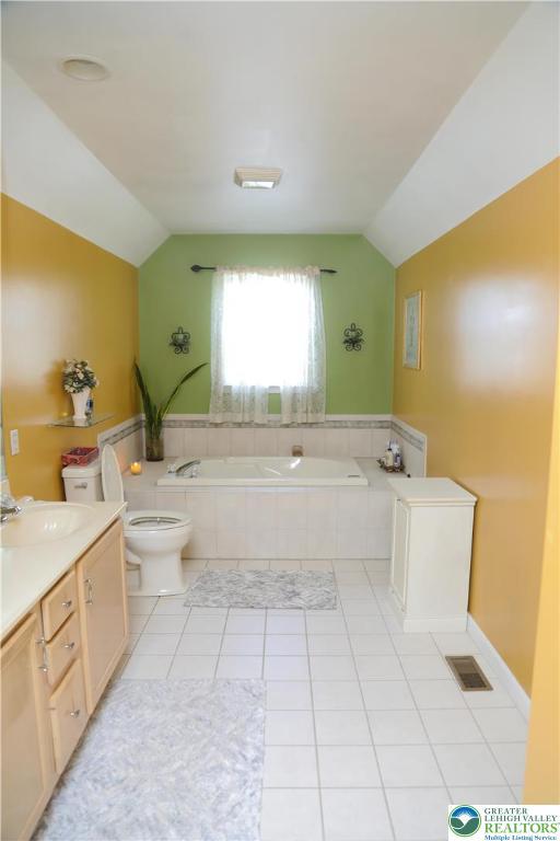 3104 Peacock Dr, Bethlehem Twp, PA 18020 - full bathroom with lofted ceiling, a bath, tile patterned floors, and vanity