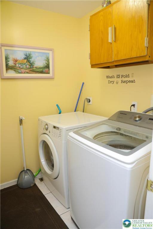 3104 Peacock Dr, Bethlehem Twp, PA 18020 - laundry room with cabinet space, washer and dryer, and light tile patterned flooring