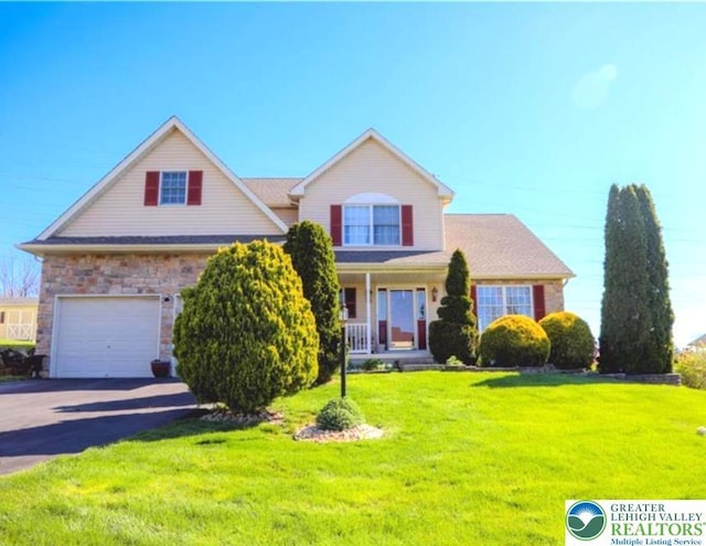 3104 Peacock Dr, Bethlehem Twp, PA 18020 - traditional-style home featuring a front lawn, asphalt driveway, a garage, a porch, and stone siding