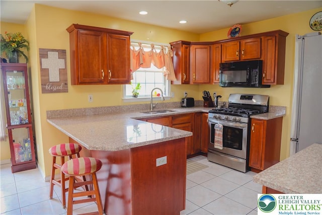 3104 Peacock Dr, Bethlehem Twp, PA 18020 - kitchen featuring stainless steel appliances, a peninsula, light tile patterned flooring, a breakfast bar, and recessed lighting
