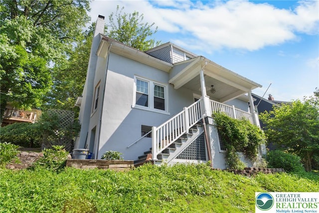 827 Wilbur St, Easton, PA 18042 - view of front of property featuring stucco siding, a chimney, and stairway