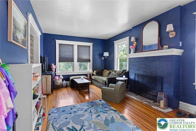 827 Wilbur St, Easton, PA 18042 - living room featuring wood-type flooring and a brick fireplace