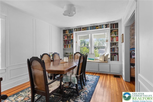 827 Wilbur St, Easton, PA 18042 - dining space with light wood-style flooring, built in features, and a decorative wall