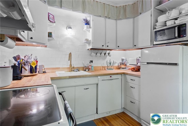 827 Wilbur St, Easton, PA 18042 - kitchen featuring white appliances, exhaust hood, tasteful backsplash, and white cabinets
