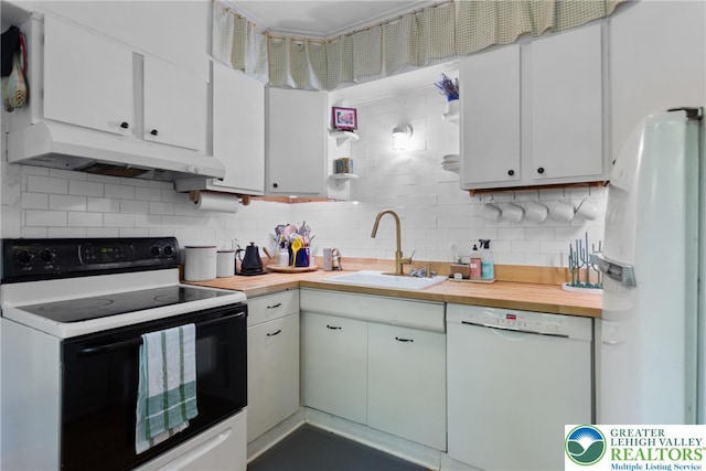 827 Wilbur St, Easton, PA 18042 - kitchen featuring white appliances, under cabinet range hood, decorative backsplash, and white cabinetry