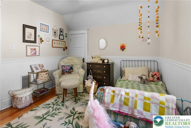 827 Wilbur St, Easton, PA 18042 - bedroom featuring vaulted ceiling, wood finished floors, and wainscoting