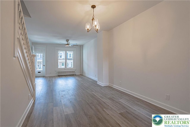 622 N Jefferson St, Allentown City, PA 18102 - unfurnished room featuring radiator heating unit, dark wood-style flooring, a chandelier, and ceiling fan