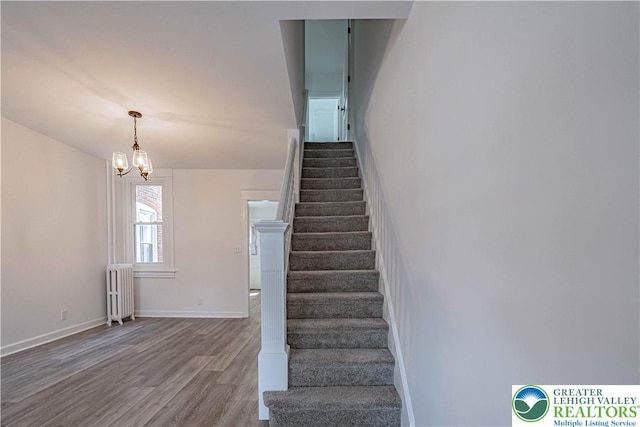 622 N Jefferson St, Allentown City, PA 18102 - stairs with radiator heating unit, wood finished floors, and a chandelier