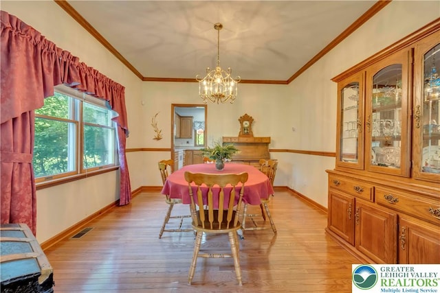 101 Blackstone Dr, Bushkill Twp, PA 18091 - dining area with a chandelier, light wood-style floors, and ornamental molding