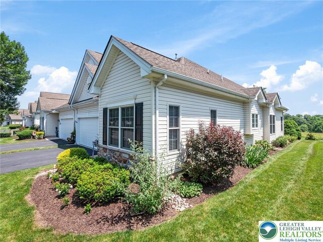 4112 Pine Hurst Dr, Allen Twp, PA 18067 - view of side of home featuring an attached garage, asphalt driveway, a shingled roof, and a lawn