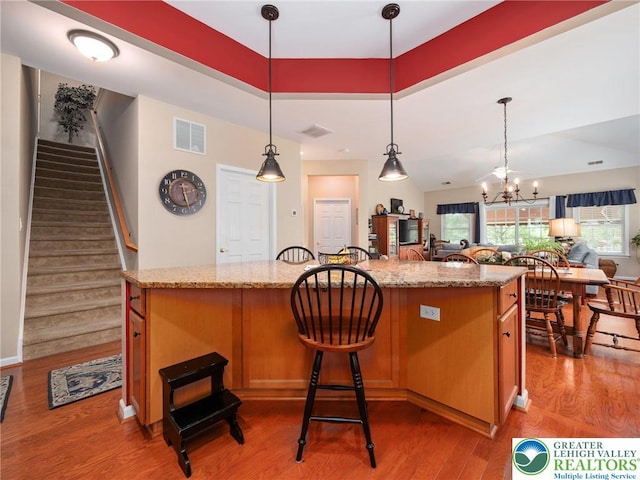 4112 Pine Hurst Dr, Allen Twp, PA 18067 - kitchen featuring open floor plan, wood finished floors, healthy amount of natural light, and a chandelier