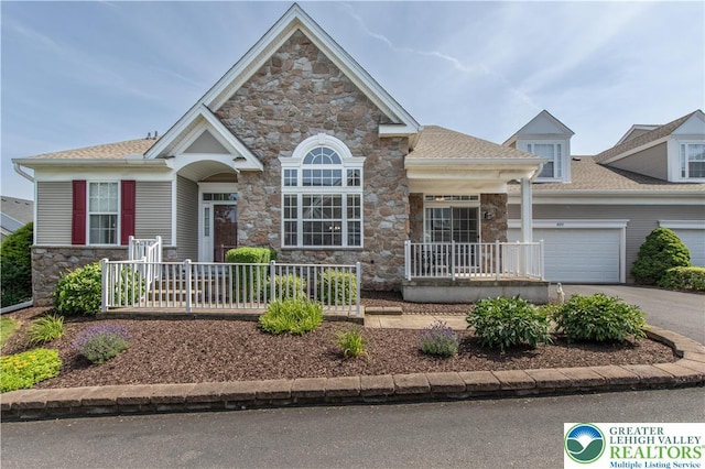1880 Felicity Ln, Lower Saucon Twp, PA 18055 - view of front of property with stone siding, a porch, asphalt driveway, and a garage
