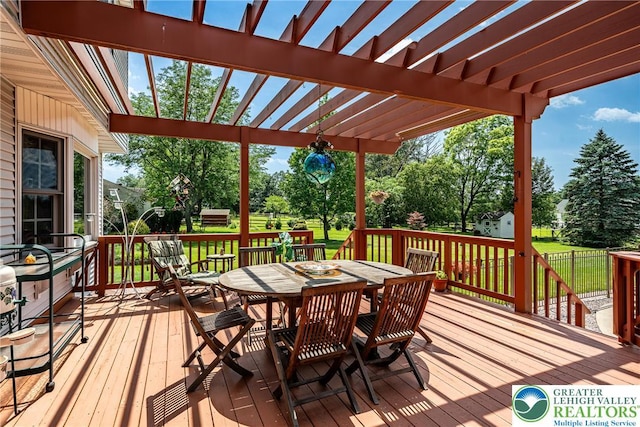 530 Station Rd, Richland Twp, PA 18951 - wooden deck featuring outdoor dining area, a pergola, view of scattered trees, and a lawn