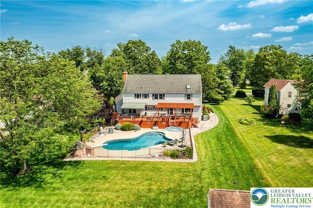 530 Station Rd, Richland Twp, PA 18951 - rear view of property featuring a wooden deck, an outdoor pool, a chimney, a patio, and view of scattered trees