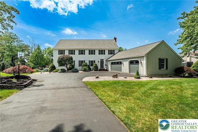530 Station Rd, Richland Twp, PA 18951 - colonial-style house with driveway, a front lawn, an attached garage, and a chimney