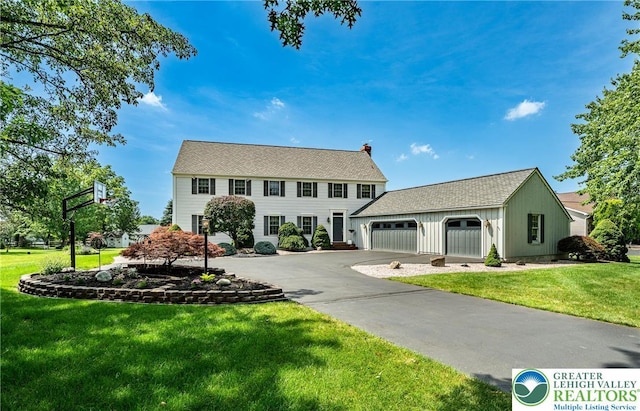 530 Station Rd, Richland Twp, PA 18951 - colonial house featuring driveway, a front lawn, an attached garage, and a chimney