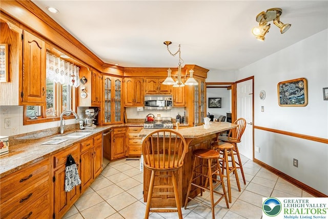 530 Station Rd, Richland Twp, PA 18951 - kitchen with appliances with stainless steel finishes, light tile patterned flooring, tasteful backsplash, and brown cabinets