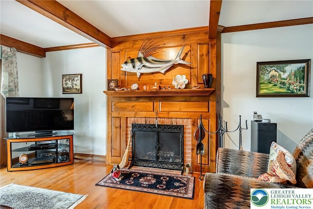 530 Station Rd, Richland Twp, PA 18951 - living area featuring a brick fireplace, beam ceiling, wood finished floors, and ornamental molding
