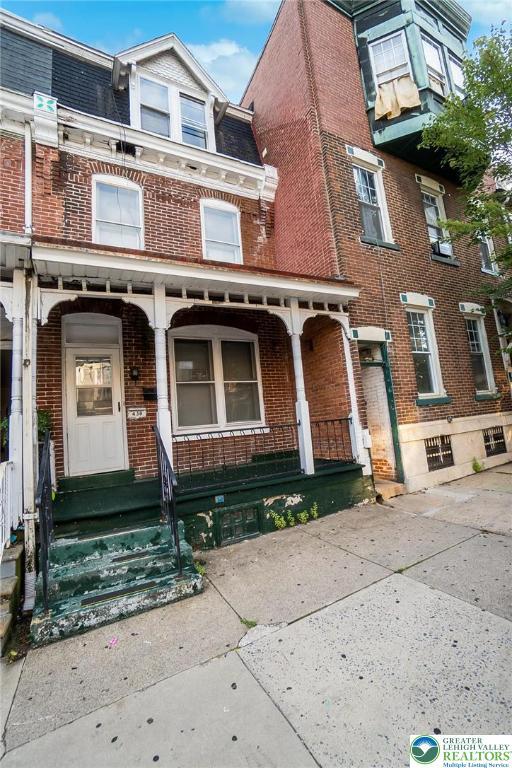 438 N 9th St, Allentown City, PA 18102 - view of front of property featuring brick siding and covered porch