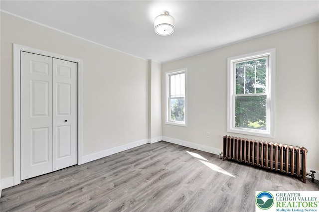 308 Washington St, Tamaqua Boro, PA 18252 - unfurnished bedroom with radiator heating unit, wood finished floors, and a closet