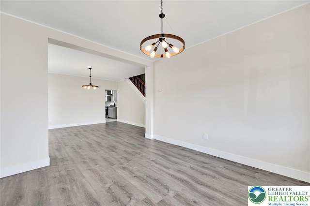 308 Washington St, Tamaqua Boro, PA 18252 - unfurnished living room with a chandelier, stairs, and wood finished floors