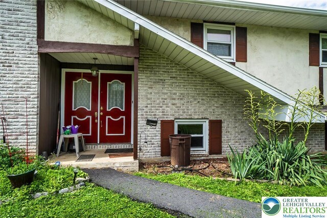 2057 Grove St, South Whitehall Twp, PA 18104 - property entrance featuring brick siding and stucco siding