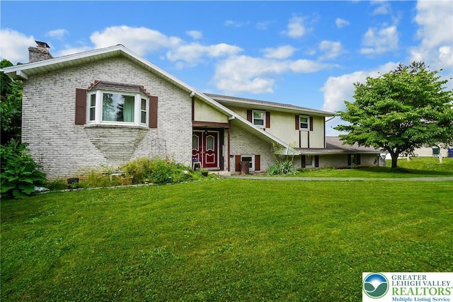 2057 Grove St, South Whitehall Twp, PA 18104 - view of front of home with brick siding, a chimney, a front lawn, and stucco siding