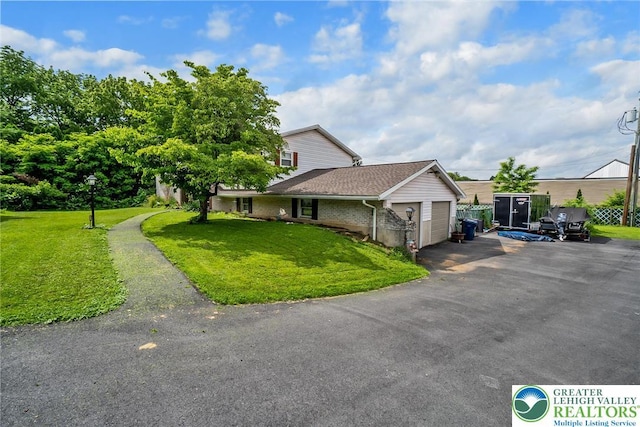 2057 Grove St, South Whitehall Twp, PA 18104 - view of front of property featuring a garage, a front lawn, asphalt driveway, and brick siding