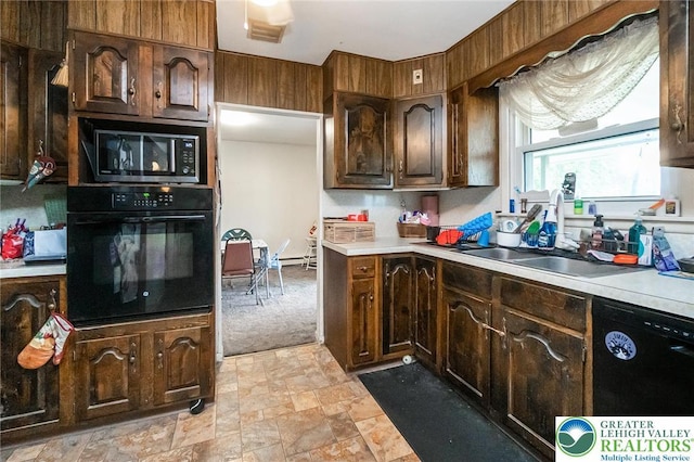 2057 Grove St, South Whitehall Twp, PA 18104 - kitchen featuring black appliances, light countertops, stone finish flooring, and dark brown cabinetry