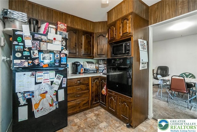 2057 Grove St, South Whitehall Twp, PA 18104 - kitchen featuring black appliances, stone finish flooring, and light countertops
