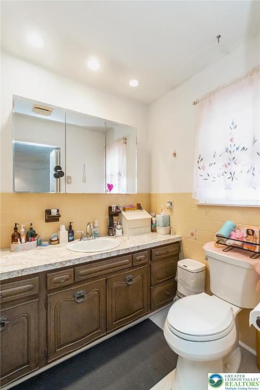 2057 Grove St, South Whitehall Twp, PA 18104 - bathroom featuring tile walls, vanity, and a wainscoted wall