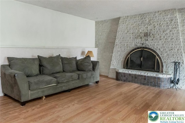 2057 Grove St, South Whitehall Twp, PA 18104 - living area with wood finished floors, a fireplace, and a textured ceiling