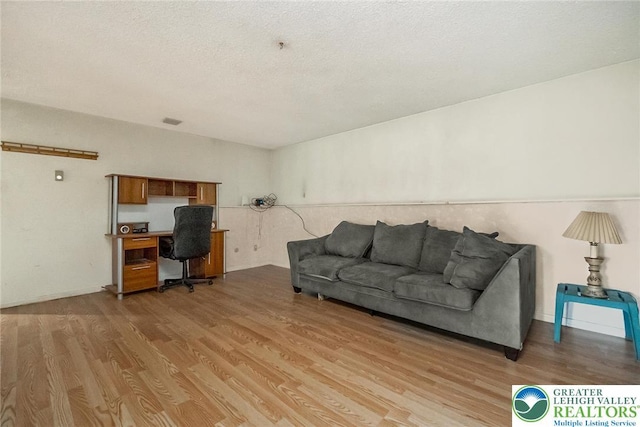 2057 Grove St, South Whitehall Twp, PA 18104 - living room with a desk, light wood finished floors, and a textured ceiling