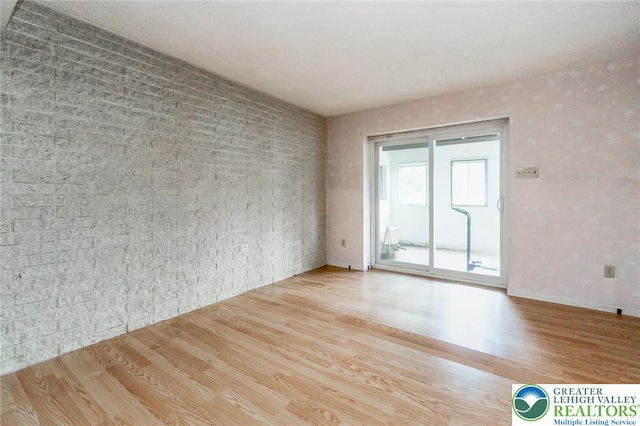 2057 Grove St, South Whitehall Twp, PA 18104 - empty room with wood finished floors and brick wall