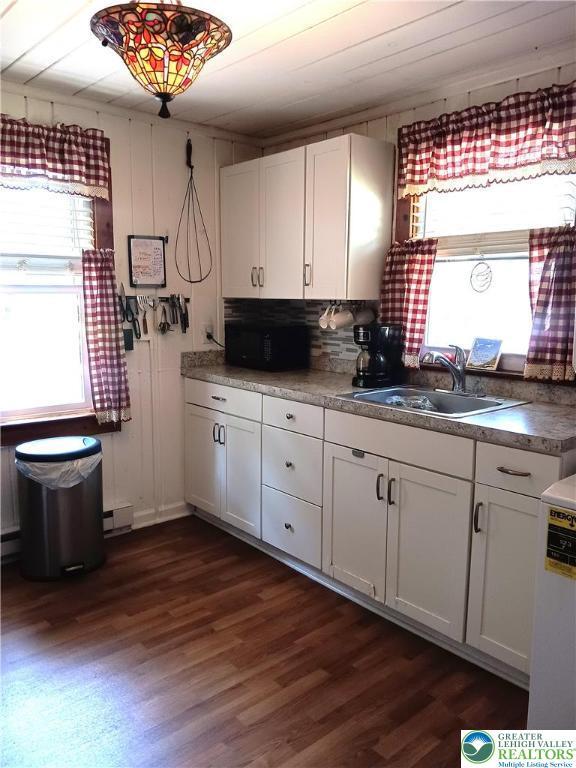 618 Mccabe Ln, Hamilton Twp, PA 18353 - kitchen featuring healthy amount of natural light, dark wood finished floors, and white cabinets
