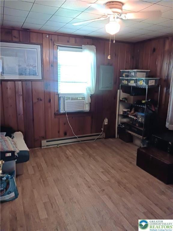 618 Mccabe Ln, Hamilton Twp, PA 18353 - office area with baseboard heating, a ceiling fan, light wood finished floors, wooden walls, and cooling unit