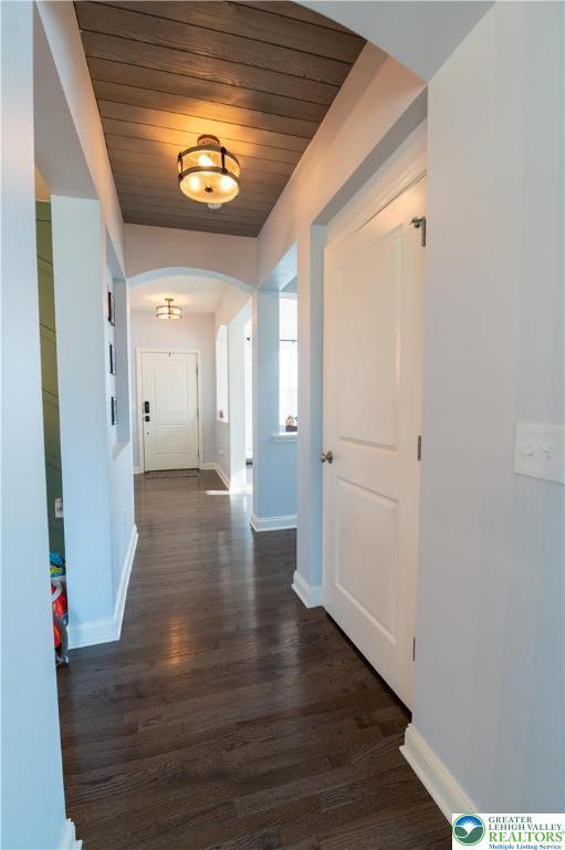 420 Rinaldi Ln, Forks Twp, PA 18040 - corridor with arched walkways, dark wood-style floors, and wood ceiling