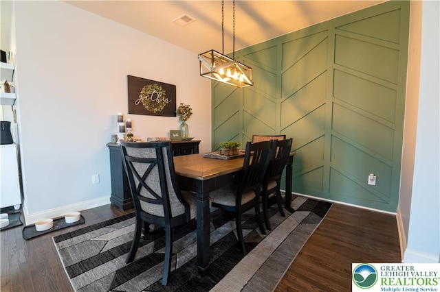420 Rinaldi Ln, Forks Twp, PA 18040 - dining room featuring dark wood-style floors, a chandelier, and a decorative wall