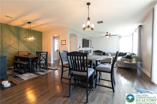 420 Rinaldi Ln, Forks Twp, PA 18040 - dining space with arched walkways, ceiling fan, and dark wood finished floors
