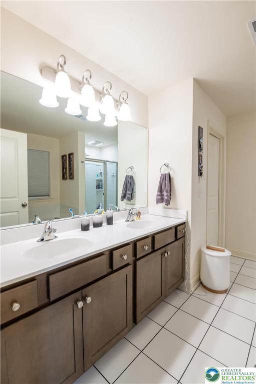 420 Rinaldi Ln, Forks Twp, PA 18040 - bathroom with double vanity, tile patterned floors, and an enclosed shower