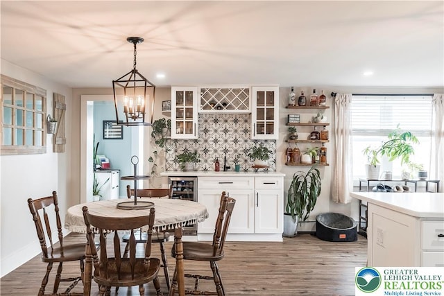 7056 Behler Rd, Lynn Twp, PA 18066 - dining area featuring a bar, wood finished floors, beverage cooler, recessed lighting, and a chandelier