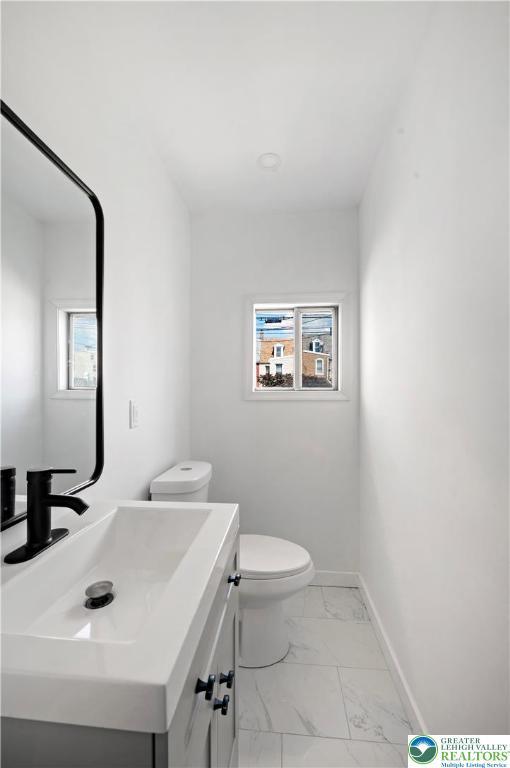907 N 5th St, Allentown City, PA 18102 - bathroom featuring marble look tile flooring and vanity