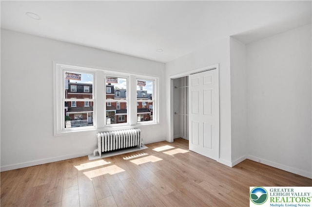 907 N 5th St, Allentown City, PA 18102 - bedroom with radiator, light wood-type flooring, and a closet
