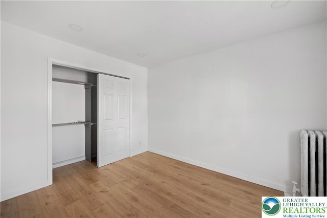 907 N 5th St, Allentown City, PA 18102 - unfurnished bedroom with radiator, light wood finished floors, and a closet