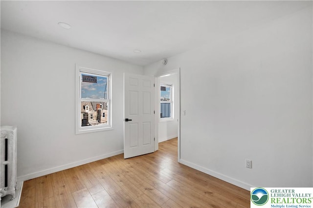 907 N 5th St, Allentown City, PA 18102 - empty room with radiator heating unit and light wood finished floors