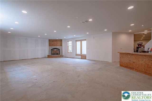 2650 Eagle Ln, Lower Saucon Twp, PA 18055 - unfurnished living room with unfinished concrete floors, recessed lighting, and a fireplace